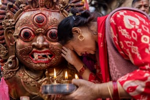 A woman bows and prays