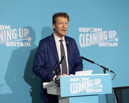 Richard Tice stood at a lectern with ‘Reform, cleaning up Britain’ written on it