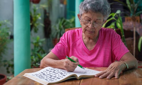 Senior woman doing puzzles in a book