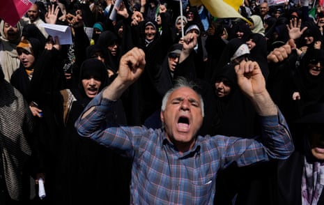 People chant slogans during a protest to condemn Israeli attacks on multiple cities across Iran, after the Friday prayers ceremony in Tehran.