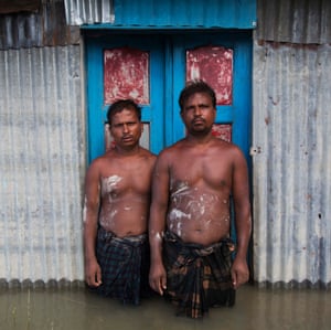 Ripon Islam and Tarajul Islam in Chandanbaisa Village Sariakandi Upazila, Bangladesh outside flooded home