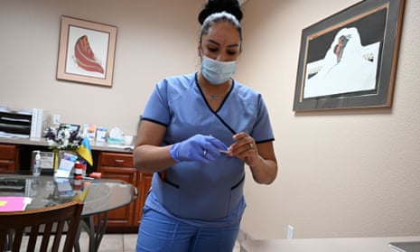 A medical assistant checks a patient's pregnancy test result at a clinic in Santa Teresa, New Mexico.