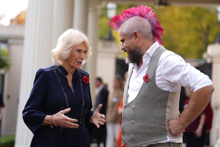Queen Camilla with TikTok star Spudman, who has a bright pink mohawk hairstyle