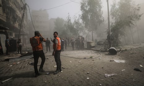 Palestinians inspect a destroyed area after Israeli airstrikes in Gaza.
