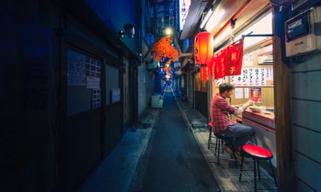 Man eating alone at noodle bar