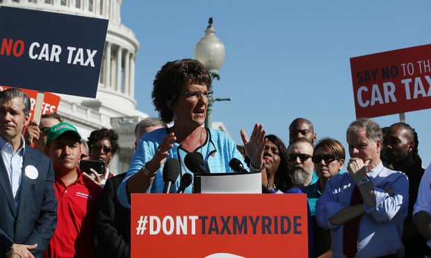 Walorski at podium that says 'don't tax my ride', with others gathered around her