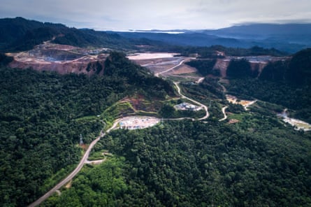 Aerial view of a mine surrounded by rainforest and mountains