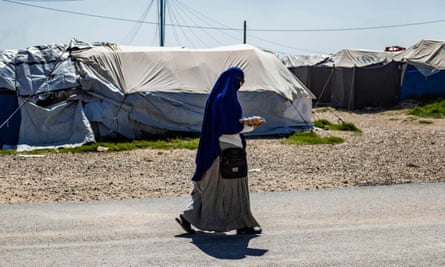 A woman walks through the Kurdish-run Roj camp in Syria's north-east in 2021.