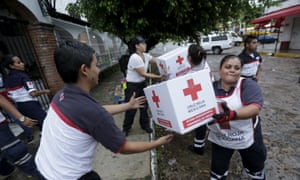 Red Cross volunteers load humanitarian aid boxes from a truck in the Pacific beach resort of Puerto Vallarta, Mexico, on Saturday.