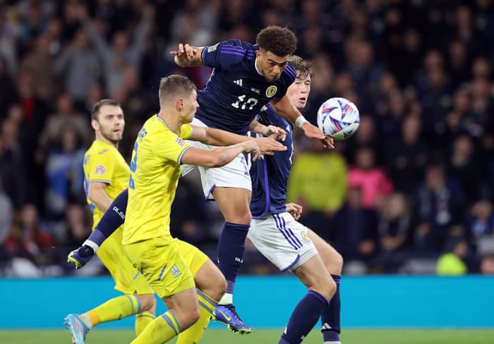 Scotland's Che Adams heads the goal.