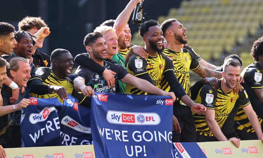 Watford players celebrate their promotion to the Premier League after the final whistle.
