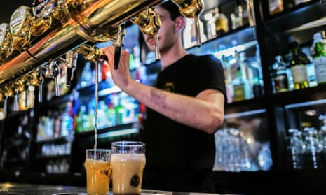 Man serving beer at a pub in France.