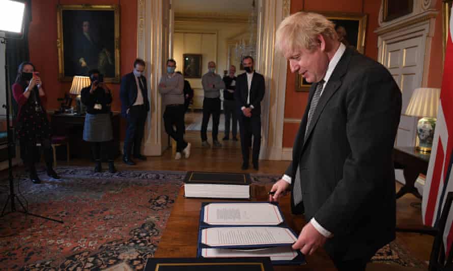No 10 staff watching as Boris Johnson signs the bill.