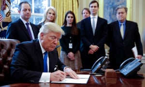 Donald Trump signs one of five executive orders related to the oil pipeline industry, at the White House in Washington DC Tuesday.