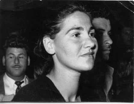 a woman standing with other people around her