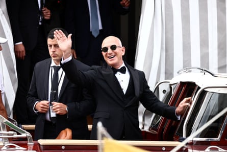Jeff Bezos waving while wearing a tux