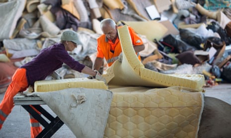 Workers dismantle a mattress in a recycling plant in Darmstadt, Germany