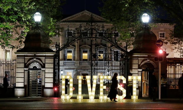The word divest is spelt out in lights in the street outside the Irish Parliament