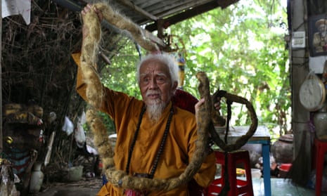 Nguyen Van Chien, 92, shows off his 5m-long hair at his home in Tien Giang province, Vietnam.