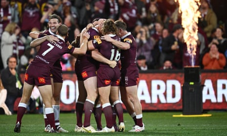 The Maroons celebrate their win over the Blues.
