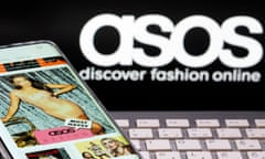 Smartphone with an Asos app and a keyboard pictured in front of a displayed Asos logo