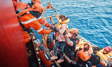A migrant is brought on board Sea-Eye 4 during a rescue mission.