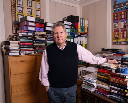 Lownie surrounded by piles of books