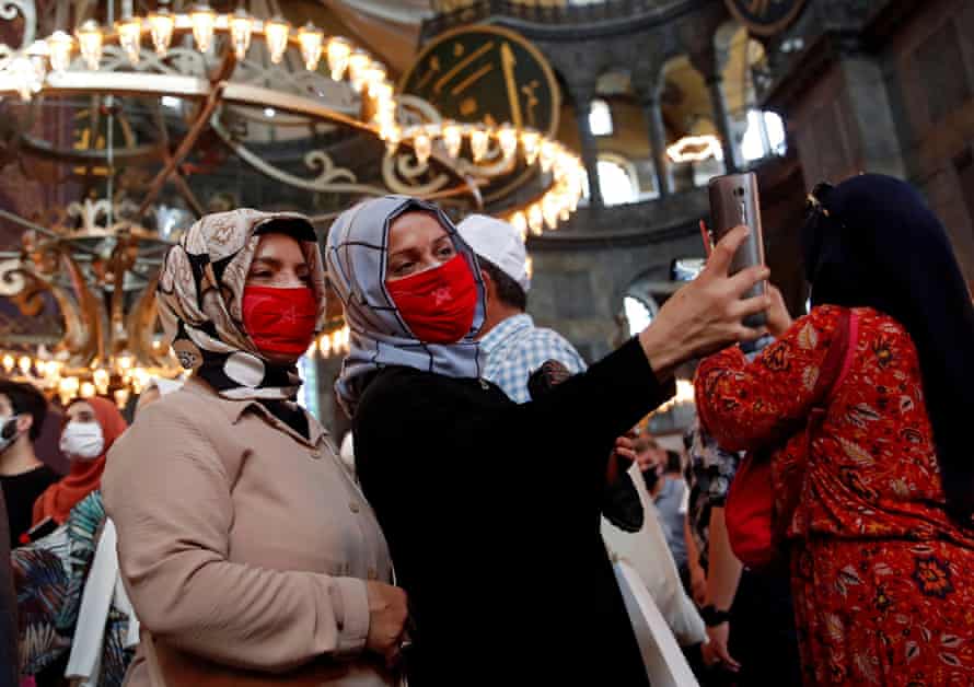 Women take a selfie at the mosque.