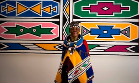 Esther Mahlangu poses in front of one of her artworks at the Melrose Gallery in Johannesburg