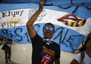 Fans carry an Argentinian flag on their way to the Ciudad Deportiva de la Habana sports complex where the Rolling Stones’ free outdoor concert will take place
