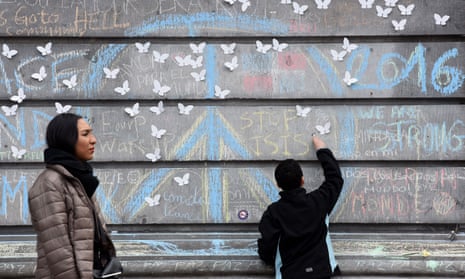 A boy writes ‘Stop Isis’ in chalk in memory of the victims of the Brussels attacks in 2016.