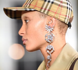 Adwoa Aboah in a Burberry cap on the catwalk.
