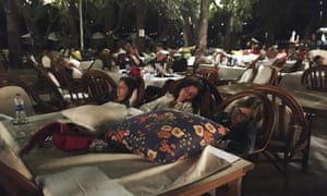 Hotel guests sleep outdoors in Bitez, about 6km from Bodrum, after abandoning their rooms following the earthquake.