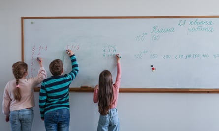 Ukrainian schoolchildren write on a whiteboard in class in Berli