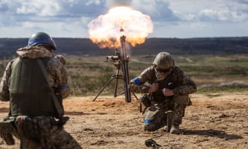 Ukrainian soldiers fire with mortar during a military training with French servicemen.