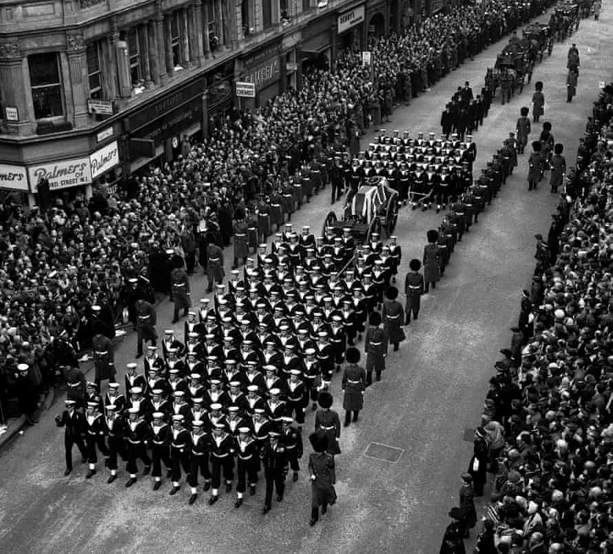 Crowds watch naval ratings pulling the gun carriage bearing the coffin of Sir Winston Churchill to St Paul’s Cathedral.