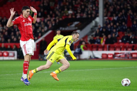Kerem Aktuerkoglu of Fenerbahce is fouled by Jair Cunha of Nottingham Forest to give Fenerbahce a penalty.