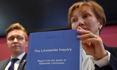Marina Litvinenko holds a copy of the inquiry report with her son Anatoly Litvinenko.