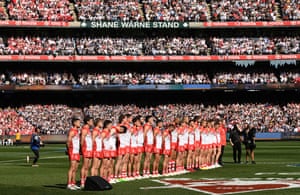 The Swans stand for the national anthem ahead.