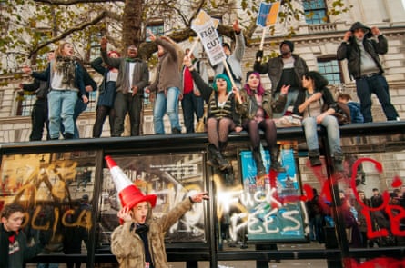 Students on a bus shelter, protesting against rising fees and grant cuts November 2010