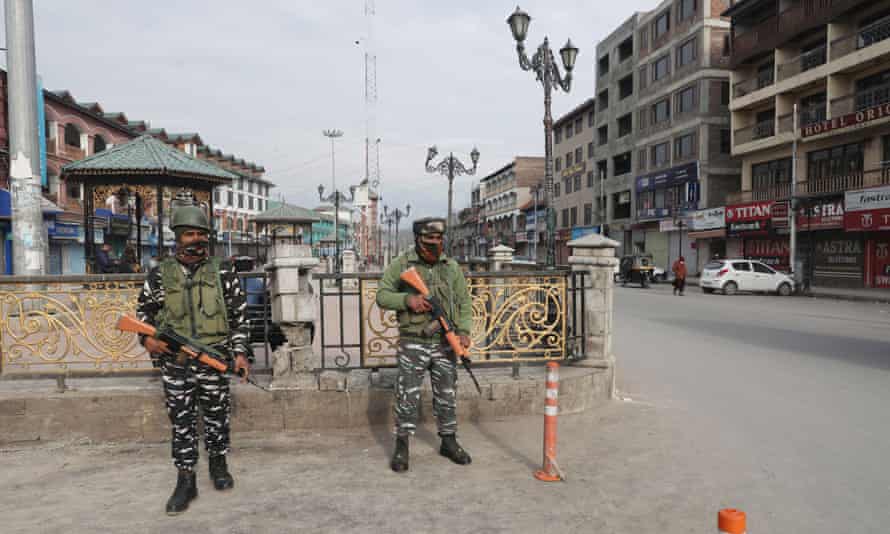 Indian paramilitary soldiers stand guard near a closed market during Covid lockdown in Srinagar, the summer capital of Indian Kashmir, India, 28 January 2022. The Jammu and Kashmir Government continued a weekend lockdown in the region as Covid cases surged. The extended weekend curfew will remain in force until 6am on Monday.