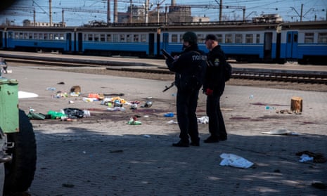 Ukrainian police examine the aftermath of a Russian missile attack on the Kramatorsk train station