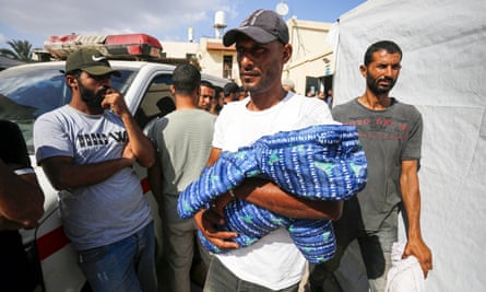The body of Fayiz Abu Ataya, who died due to malnutrition, is brought to Al-Aqsa Martyrs Hospital in Deir al Balah, Gaza, on 30 May.