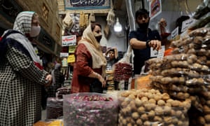 Women wearing protective face masks shop at a bazaar in Tehran. Iran has recorded more than 300,000 cases of coronavirus and more than. 16,500 deaths.