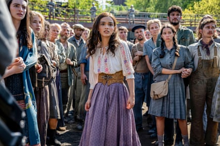 Film still of woman standing in group of people