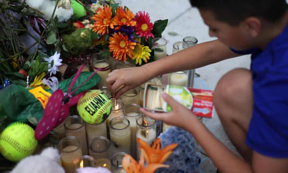 A person lights candles at a memorial dedicated to the school shooting victims in Uvalde, Texas. 