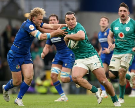 Ireland’s James Lowe (right) palms off Italy’s Louis Lynagh