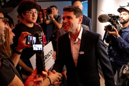 James Talarico shakes hands with people as some hold cell phones