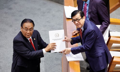 Indonesian Minister of Law and Human Rights, receives the new criminal code report from Bambang Wuryanto, head of the parliamentary commission overseeing the revision
