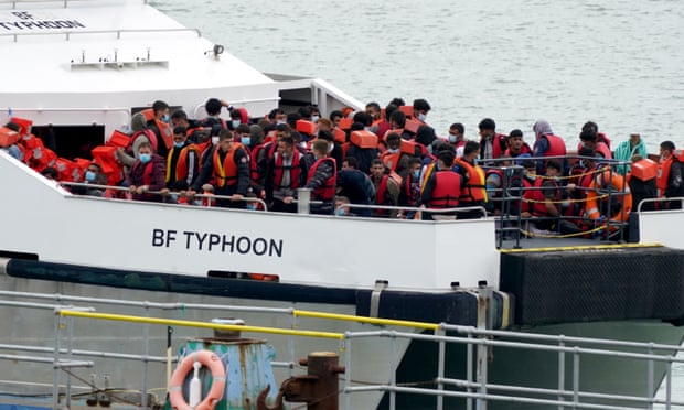A group of people thought to be asylum seekers are brought into Ramsgate, Kent.